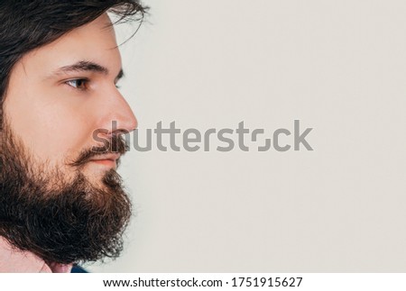 Barbershop banner. Closeup portrait of Bearded man with face in profile