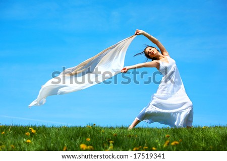 Freedom. Happy young woman running  in the field
