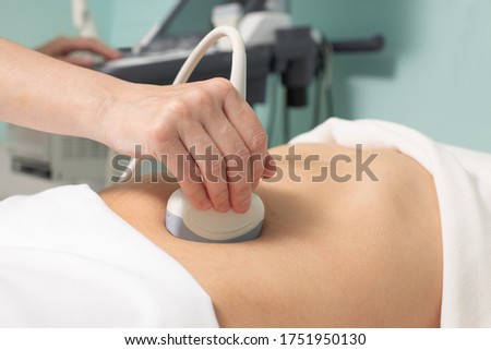 Doctor conducting ultrasound examination of woman in clinic Royalty-Free Stock Photo #1751950130