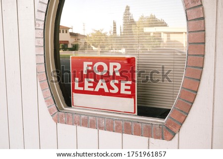 Business office with a For Lease sign in the window - Down Economy - Covid 19 - Pandemic