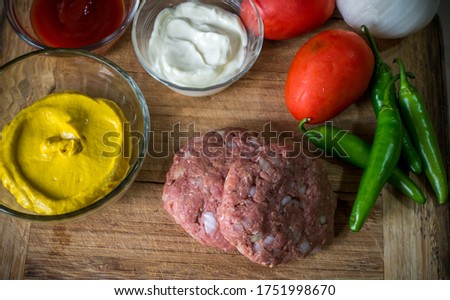 Homemade hamburger with mayonnaise, mustard and vegetables