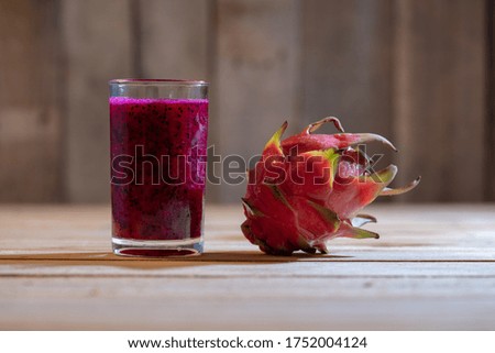 Juice Asian Dragon fruit on the wooden background