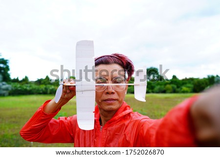 Pictures of people enjoying a rubber airplane powered by the potential energy stored by rotating propellers.