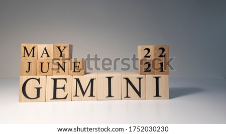 Gemini word on wooden cubes on white background. Photographed in the studio and in spot light. Zodiac or star signs consists of 12 horoscopes.