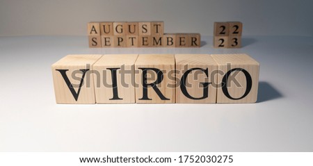 Virgo word on wooden cubes on white background. Photographed in the studio and in spot light. Zodiac or star signs consists of 12 horoscopes.