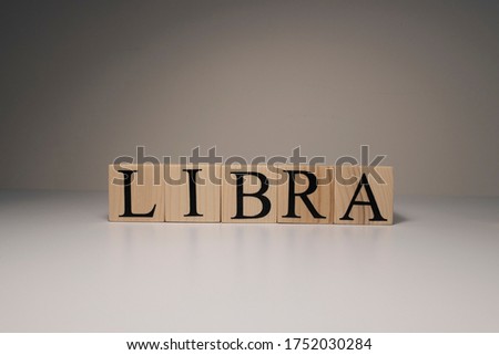 Libra word on wooden cubes on white background. Photographed in the studio and in spot light. Zodiac or star signs consists of 12 horoscopes.