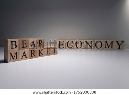 The word Bear market in wooden cubes, in white background. Photographed in the studio and in spot light. Business market concept.