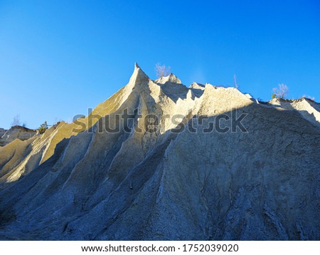 Abandoned Quarry Of Rummu, Estonia. Scenic View Of Land. Mountain of white sand and stones. Panoramic View. The erosion of limestone quarry. Sandy hill. Beautiful Texture of surface. Earth, explore. 