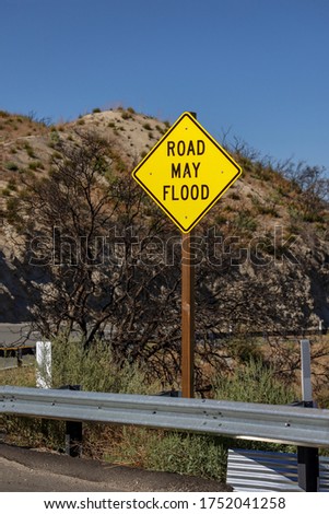 A Road May Flood sign on the side of the road  at San Bernardino Mountains.