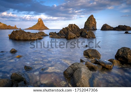                            Cyclopean Isles, Aci Trezza, Sicily, Italy.  These were the great stones thrown at Odysseus by the monster Cyclops in the epic poem "The Odyssey."      Royalty-Free Stock Photo #1752047306