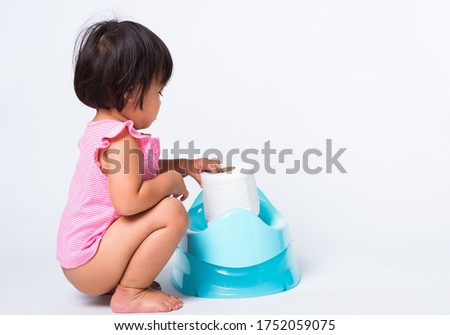 CHILDREN ASIAN GIRL SITTING ON TOILET Stock Photos and Images - Avopix.com