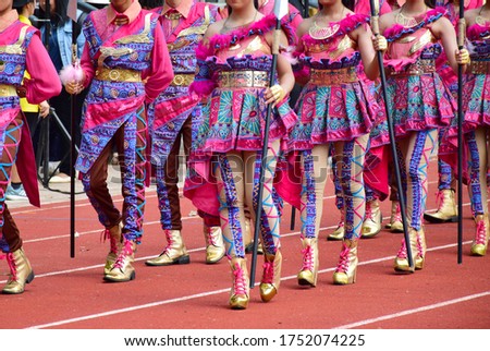 Multi-color of people of young people are wearing dress and join in parade for grand opening to ceremony. Beautiful and colorful dress display during the parade in sports competition opening ceremony