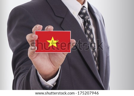 Businessman in suit holding a business card with a Vietnam Flag 