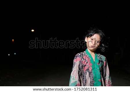 Malay girl celebrating Hari Raya Aidilfitri , posing at night