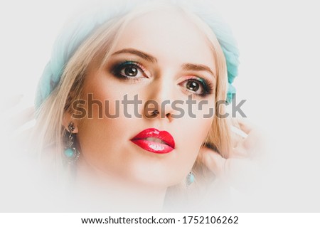 Fashion portrait of attractive young lady with professional make-up and turquoise bandage