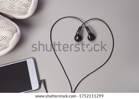 Smartphone and headphones. Podcast concept. Sport life.