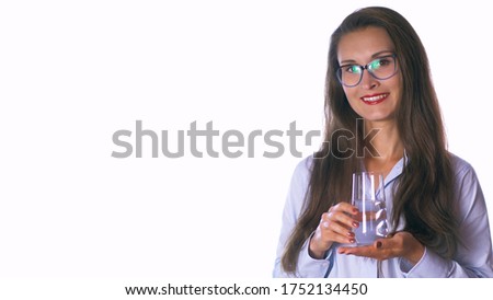 Cheerful mid-age hispanic latin woman hold a water glass. Isolated studio portrait on white. Healthy eating lifestyle and weight loss concept.
