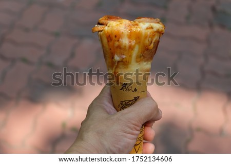 Mushroom and Ham Cone Pizza In the hand, an Italian-style snack