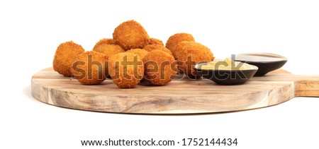 Dutch traditional snack bitterbal on a serving board, isolated Royalty-Free Stock Photo #1752144434