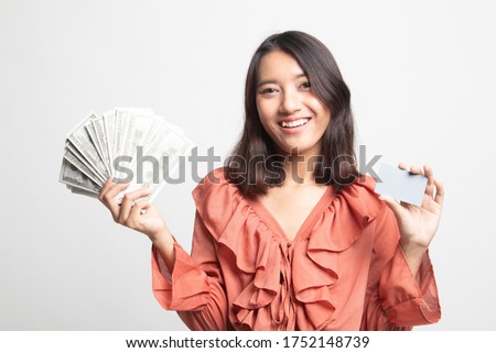 Portrait of  young asian woman  showing bunch of money banknotes on white background