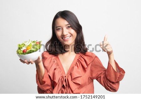 Healthy Asian woman thumbs up with salad on white background