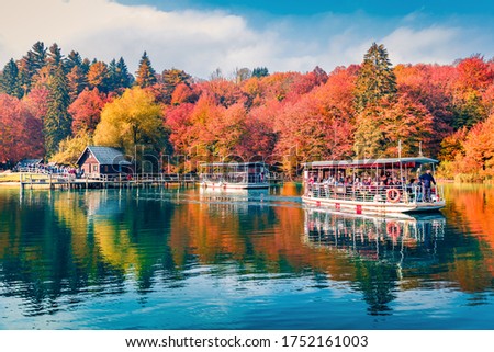 Tourists on a sightseeing boat. Attractive autumn view of Plitvice lake. Captivating morning landscape of Plitvice Lakes National Park, Croatia, Europe. Traveling concept background. Royalty-Free Stock Photo #1752161003