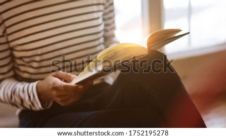 Young asian woman reading a book at home, free time hobbies.