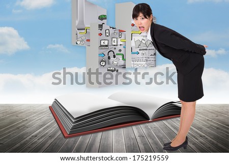 Surpised businesswoman bending against open book against sky