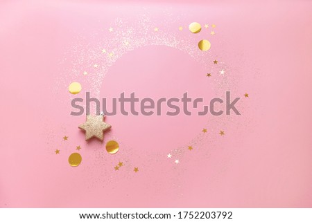 round frame made with gold glitter and star confetti on pink background perfect for Christmas template