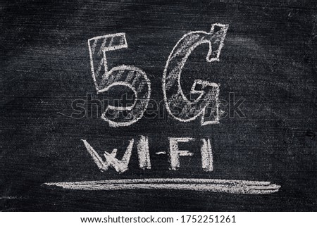 5G Wi-Fi sign on blackboard written in chalk, dirty chalkboard background