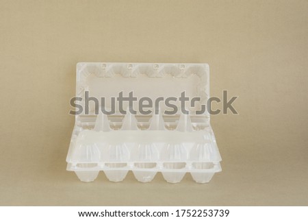 Plastic egg container on a grey background. Recycling of plastic waste. Separate waste collection. Packaging. Waste sorting. Empty container.
