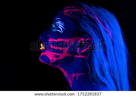 Photo of woman in profile with bright make-up in neon