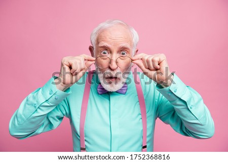 Closeup photo of excited crazy attractive grandpa open mouth listen good news astonished taking off specs wear mint shirt suspenders bow tie isolated pastel pink color background Royalty-Free Stock Photo #1752368816
