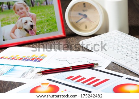 photo frame, mobile phone and notebook with a ballpoint pen. Workplace of the businessman.