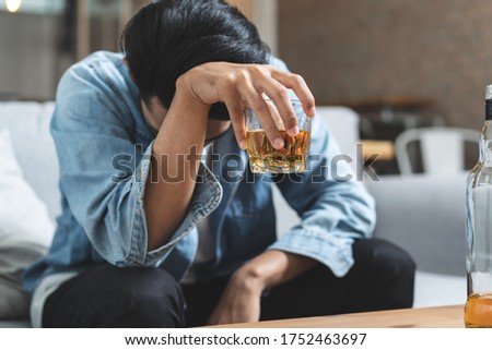 drunk asian man hold whisky glass addicted alcohol need therapy Royalty-Free Stock Photo #1752463697