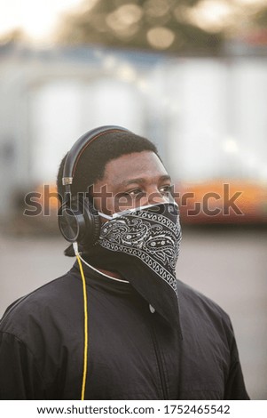 African young man listening to music in the headphones
