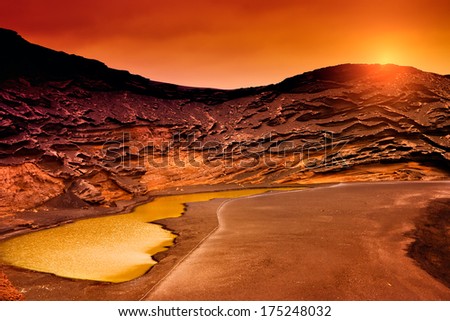 Amazing sunset in "Charco Verde", Lanzarote. Canary Islands. Royalty-Free Stock Photo #175248032