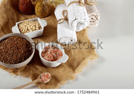 a bowl full of linseed in the company of other seeds for the production of homemade body cosmetics with empty space for text