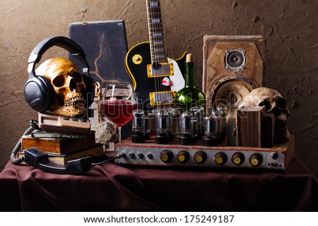 Still life fine art photography on high fidelity concept with vintage tube valve amplifier wine electric guitar and speaker 