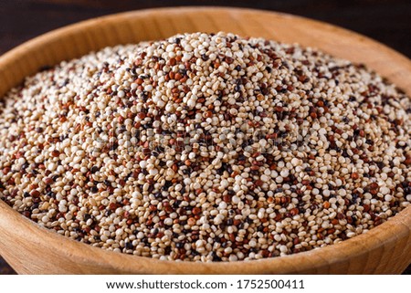 mix of quinoa grains on dark wooden rustic background