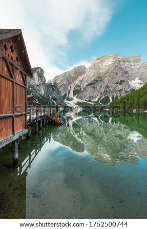 Mount Seekofel and pier of boatshouse mirroring in the clear calm water of iconic mountain lake Pragser Wildsee (Lago di Braies) in Dolomites, Unesco World Heritage, South Tyrol, Italy Royalty-Free Stock Photo #1752500744