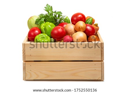 Wooden box with vegetables on a white background. Zucchini, carrots, tomatoes, cucumbers and greens. Fresh vegetables. Agricultural Products. Delivery of products. Royalty-Free Stock Photo #1752550136