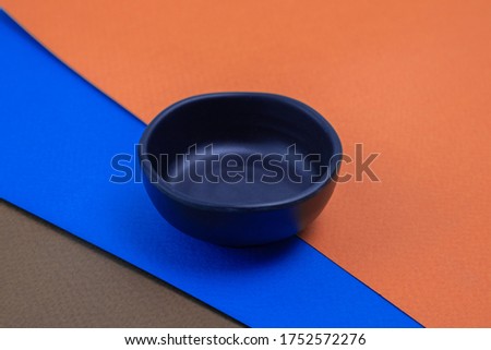 Black cup on colored paper background