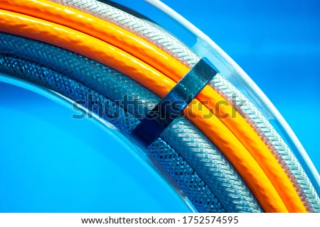 Wiring close-up. Various wires are fastened by a clamp. Concept - wiring installation. Several electrical cables nearby. A bunch of different wires. Cables of various types in the enterprise. Royalty-Free Stock Photo #1752574595