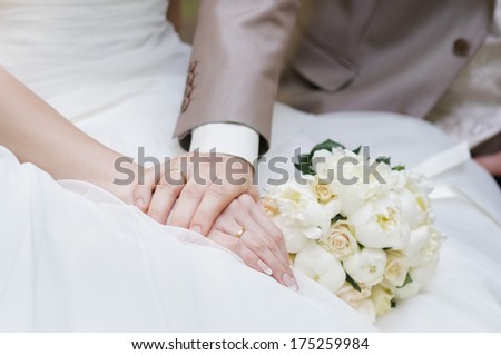  Bride and groom's hands with wedding rings 