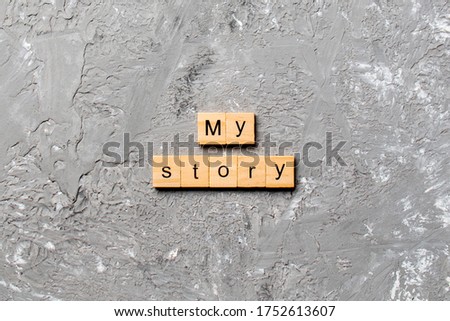 My story word written on wood block. My story text on cement table for your desing, concept.