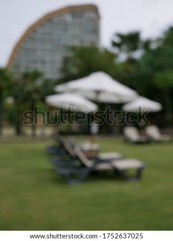 Blur focus of many umbrellas on the beach, symbolic photo for holidays, mass tourism