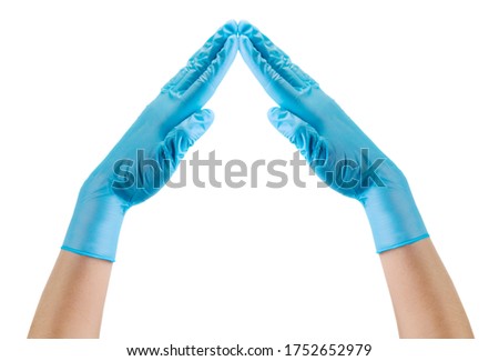 Doctor's hand in sterile medical gloves showing roof shape isolated on white background with clipping path. Concept of protection against pandemic and massage Stay at home.