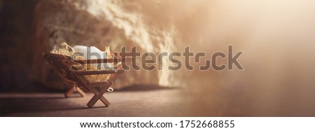 Wooden manger and star of Bethlehem in cave, nativity scene background. Christian Christmas concept. Birth of Jesus Christ. Jesus is reason for season. Salvation, Messiah, Emmanuel, God with us, hope.