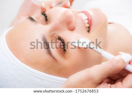 Face peeling at the beautician. Facial treatments. Photo chemical, glycolic, almond peeling. Royalty-Free Stock Photo #1752676853